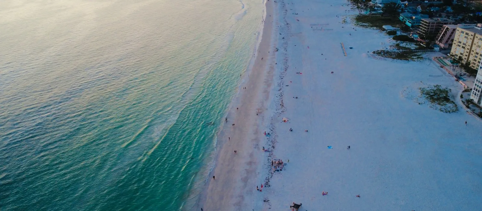Pale sand meeting clear green water on the Gulf coast