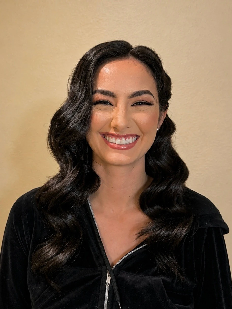 Glam makeup with old-Hollywood waves, smiling