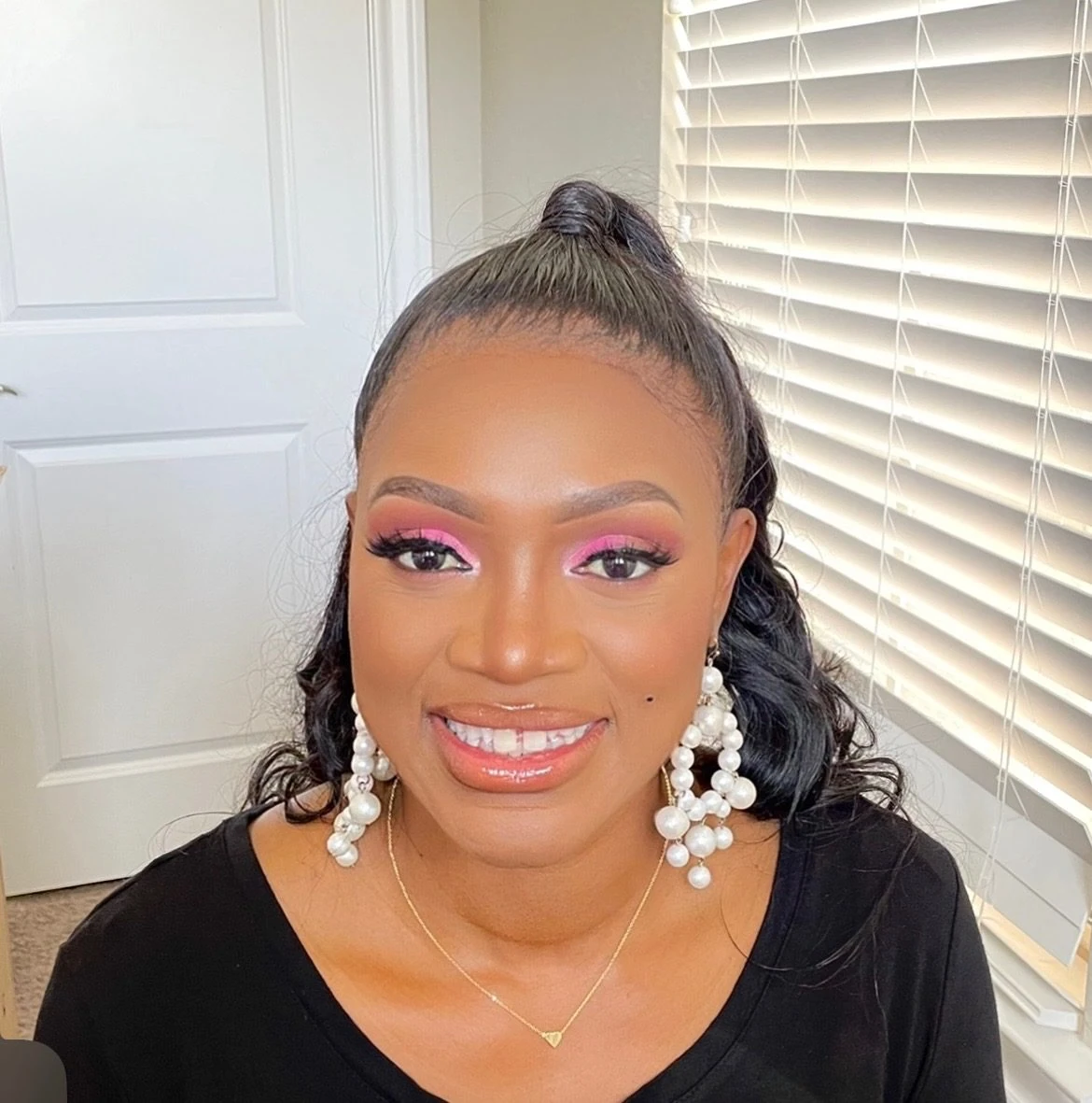 Pink glam makeup with a high curled ponytail
