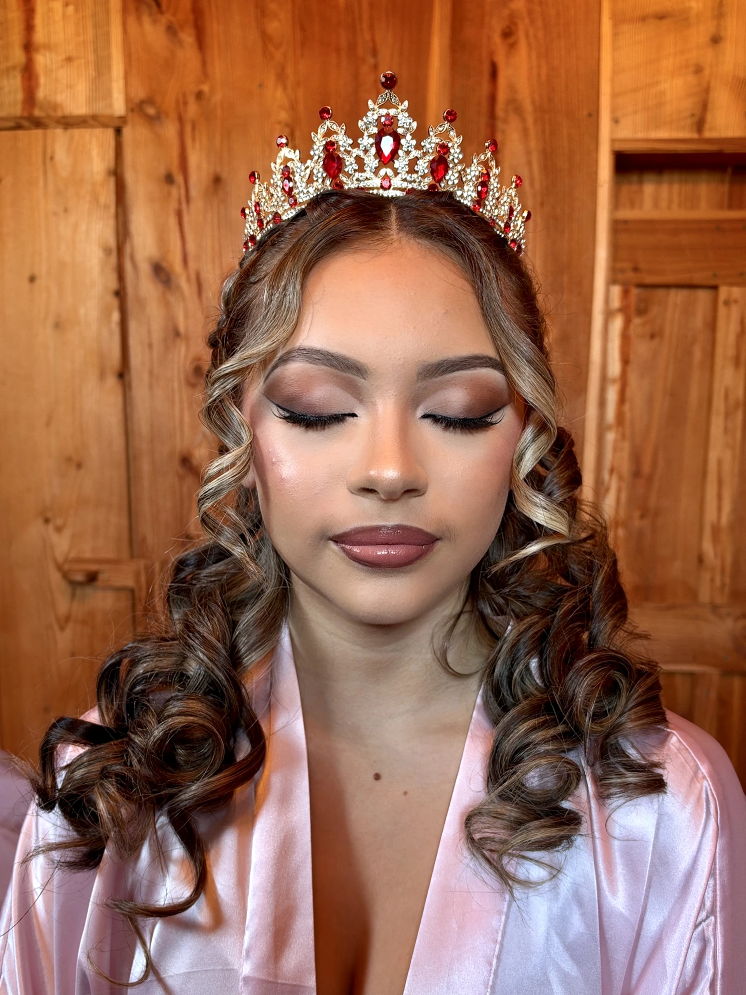 Quinceanera glam with a shimmering cut-crease eye and winged liner, eyes closed