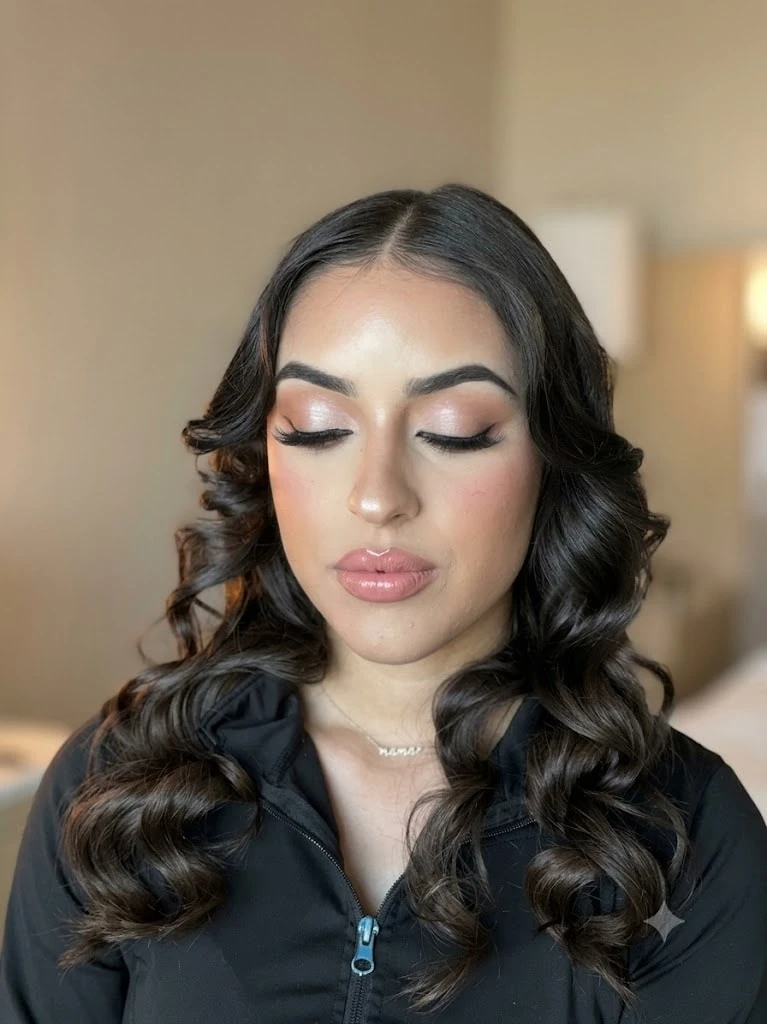 Glam makeup with eyes closed and soft curls